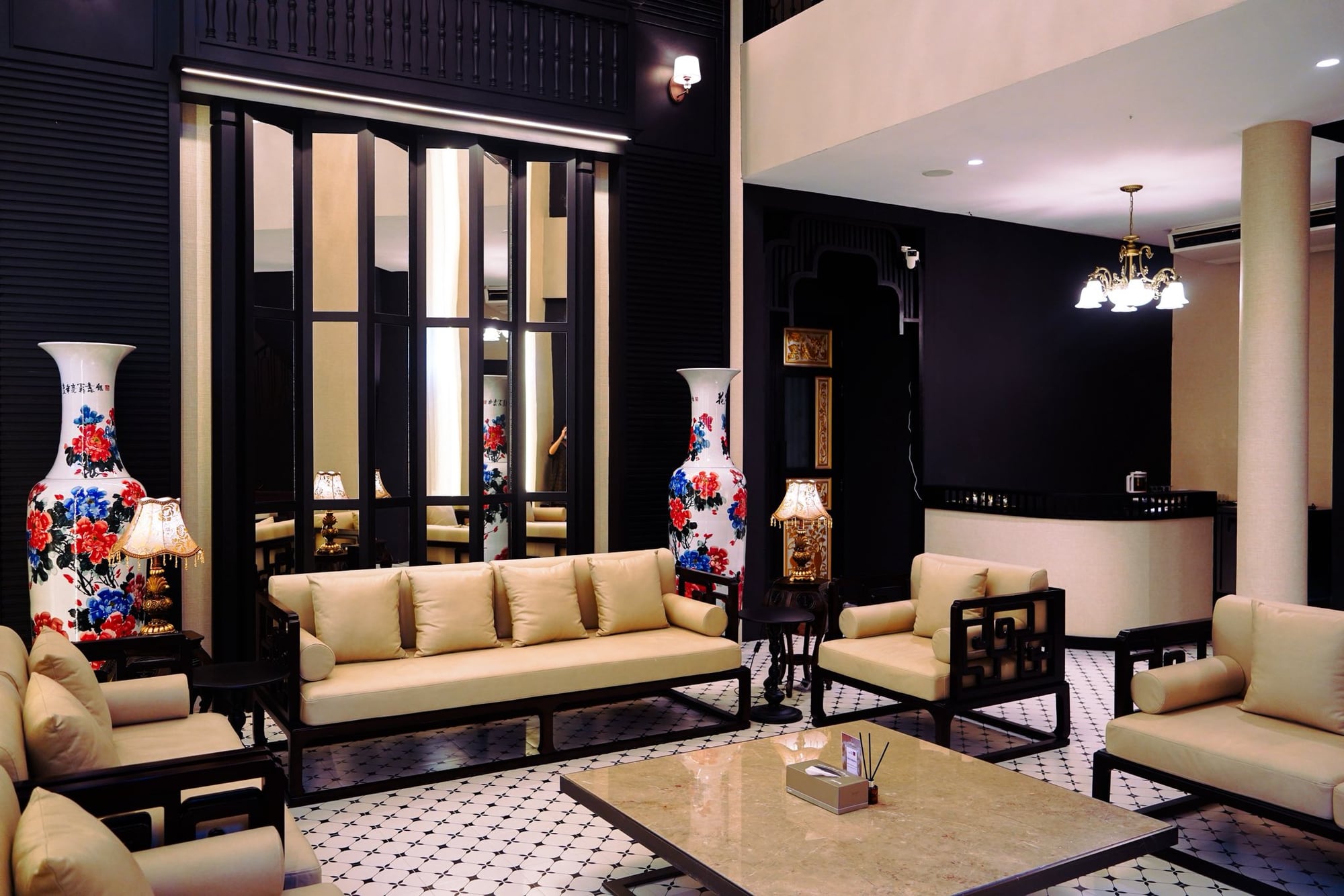 Kebaya Spa lobby — symmetrical Thai-Chinese seating, hand-painted vases, marble mosaic floor