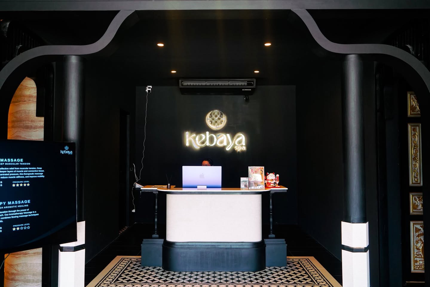 Kebaya Spa reception — illuminated Kebaya wall sign over mosaic floor
