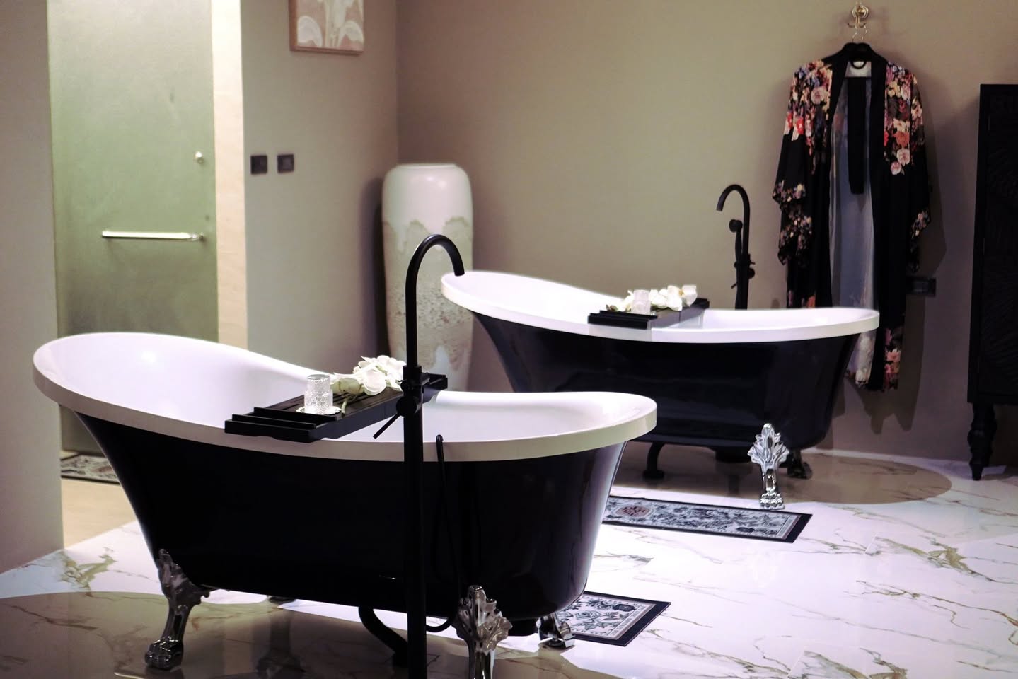 Kebaya Spa bathing room — a black freestanding tub on marble floor